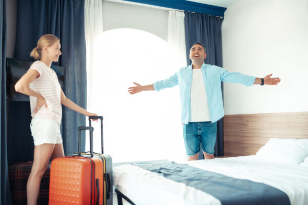 Cuplu cu bagaje într-o cameră de hotel